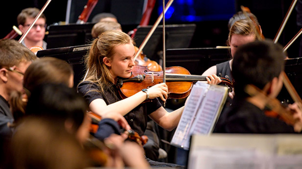 A student orchestra performs.