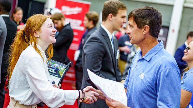 A student shakes hands with an employer at Rose-Hulman's Fall Career Fair.