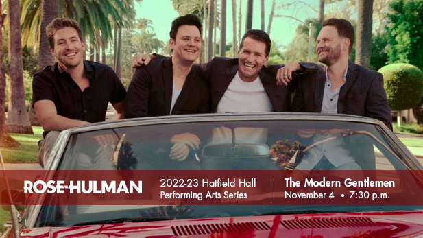 The Modern Gentlemen sitting on top of a red convertible.