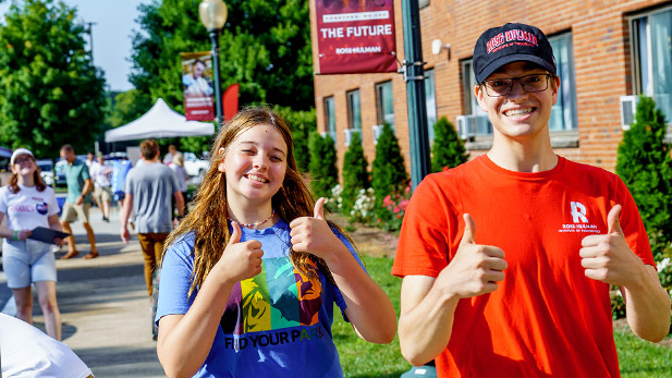 Two students give thumbs-ups on move-in day.