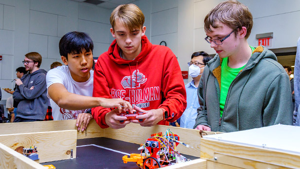 First-year students navigate their robot through the challenge course in the Kahn Room.
