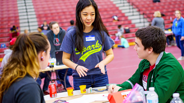 A Rose student mentor guides high school students in an activity at SPARK!