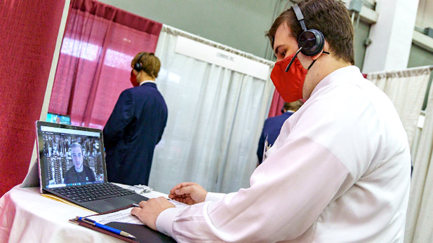 A student participates in a virtual interview using a laptop.