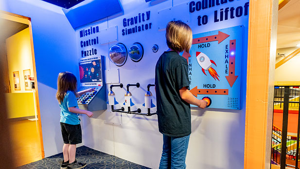 Children exploring new space station exhibit at the Terre Haute Children's Museum.