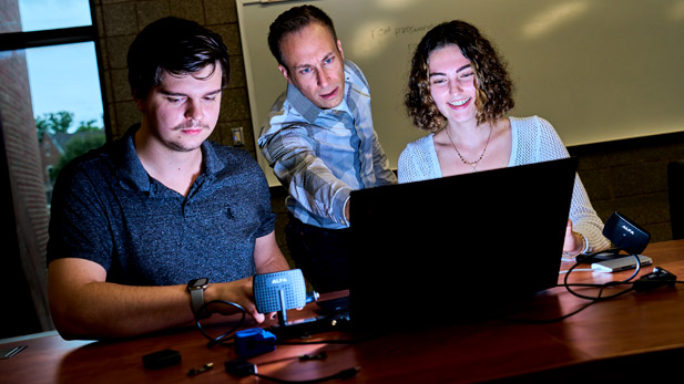 Faculty assist Rose-Hulman students with a project on the computer.