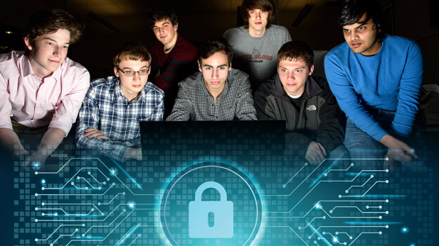 A group of students look at a computer screen intently.