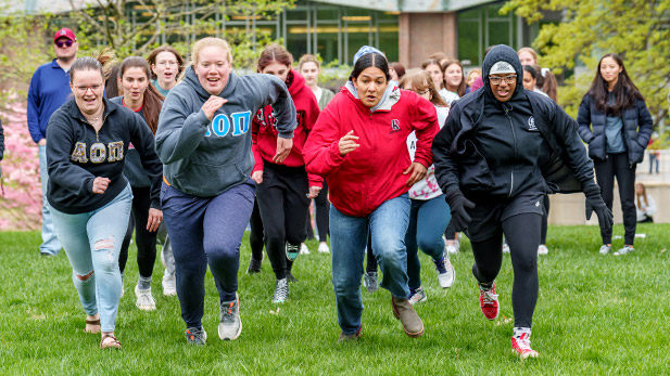 Students run across BSB lawn during Greek Games at Rose.