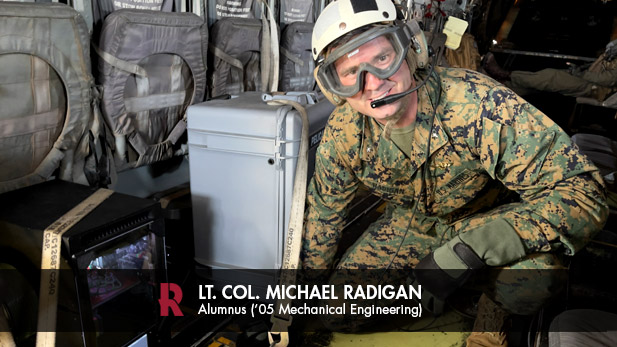 Lt. Col. Michael Radigan checks the progress of 3D printing a medical cast aboard an MV-22 Osprey during a June 2023 training flight. 