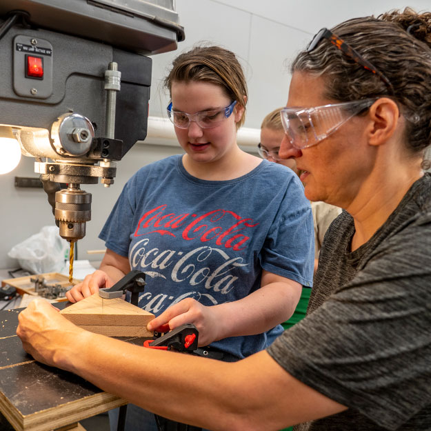 A student experiments with a robotic arm project during a Rose-Hulman summer camp.