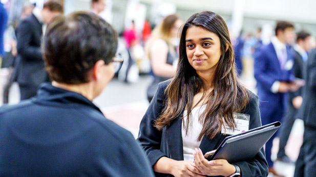 A student speaks with an employer at the Career Fair.