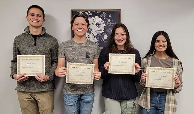 Clay D. Brown, Andrew Sander, Lainie M. Lawrence, and Gwynneth H. Menzie pose with their certificates.
