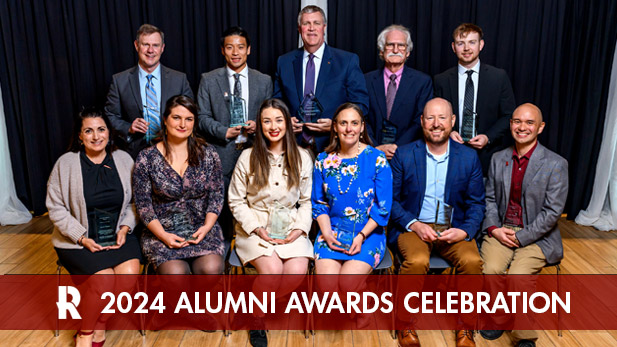 Recipients of the 2024 Alumni and Honor Alumni Awards hold their glass awards.