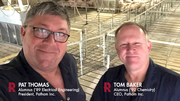 Pat Thomas and Tom Baker take a selfie in a swine production facility.