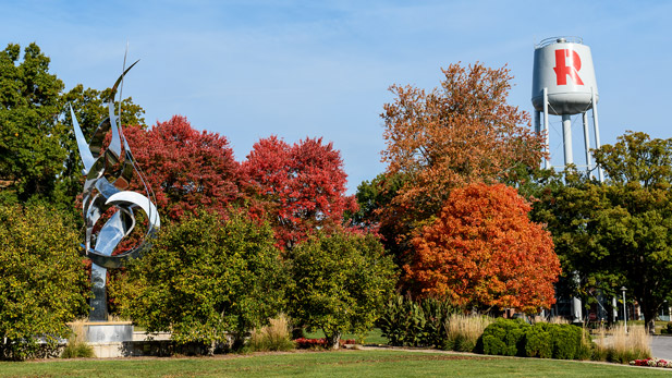 Fall foliage surrounding the Rose-Hulman water tower and the Flame of the Millennium.