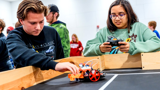 Students test their robot on the course during the ECE challenge.