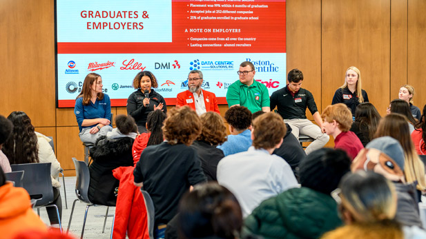 A panel of employers speaks to high school students in the Lake Room.