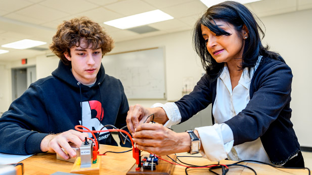 Sudipa Kirtley assists a student with the wires on a project.