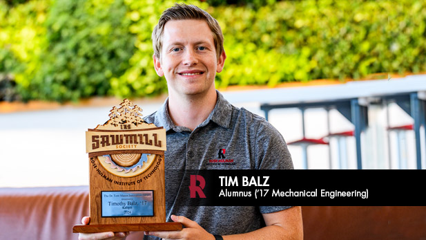 Tim Balz holds an award Rose-Hulman presented him for his innovation.