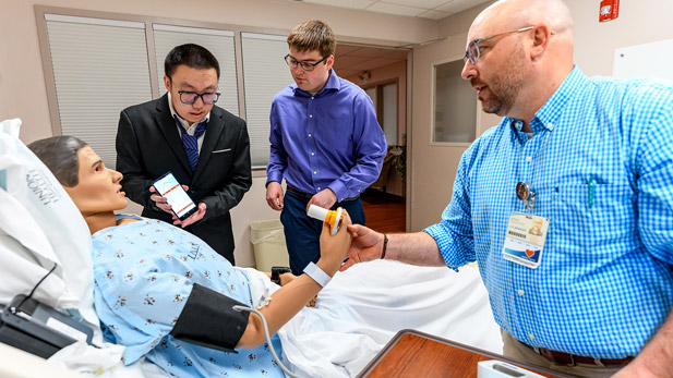 Students demonstrate their projects at Union Hospital's Physical Therapy Laboratory. 