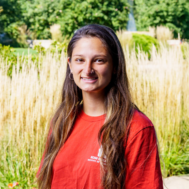 Brianna Camero-Sulak examines a container of sludge during a civil engineering lab.