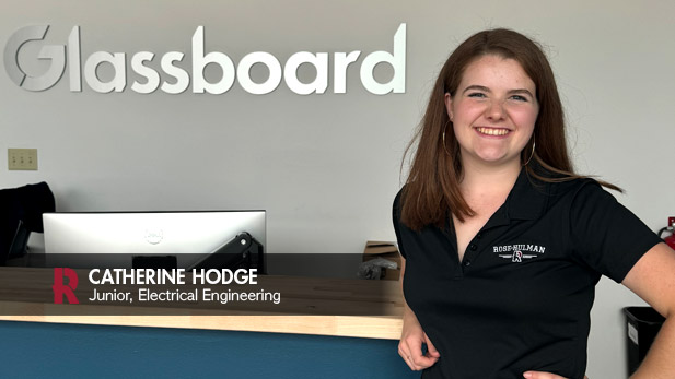 Catherine Hodge poses in front of Glassboard company sign.