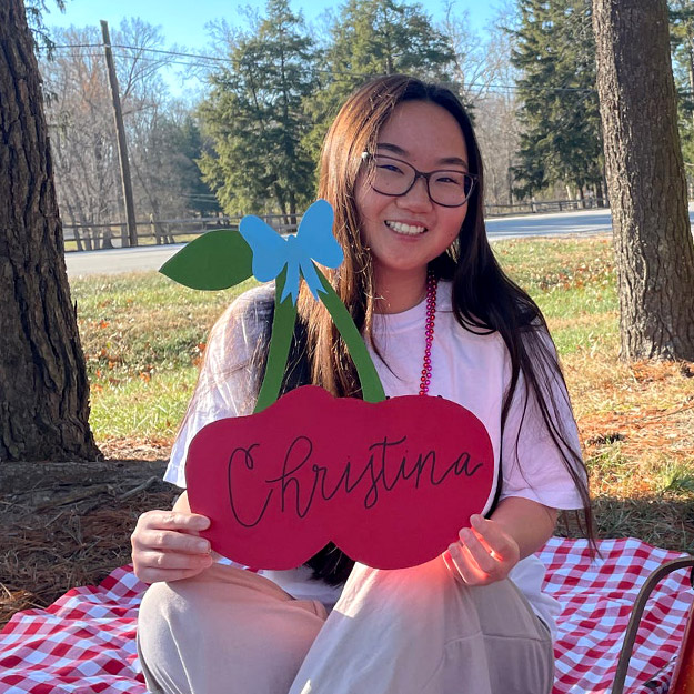 Christina Zhang is holding her name tag during Chi Omega Sorority event.