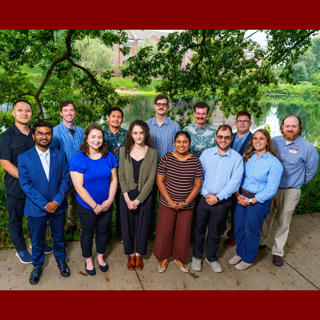 New faculty standing by Speed Lake in summer.
