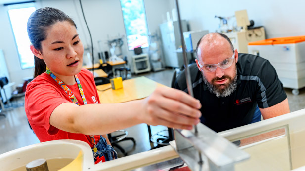 A student works alongside a faculty in multidisciplinary clean energy room.