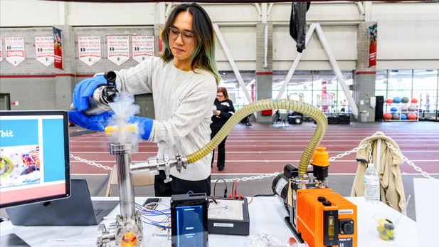 A student pours dry ice into the cryogenic testing apparatus.
