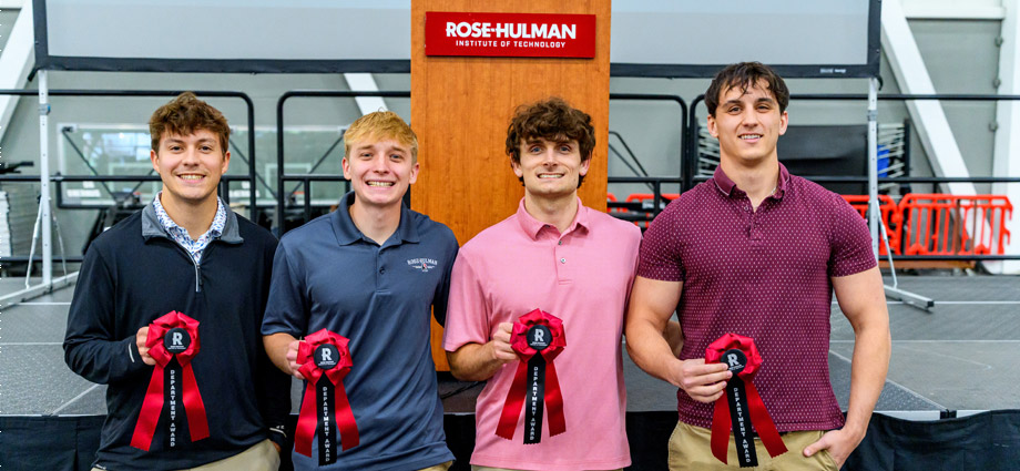 Four students pose with award ribbons.