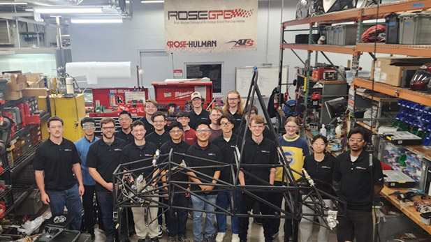 Rose Grand Prix Engineering team with their racecar chassis.