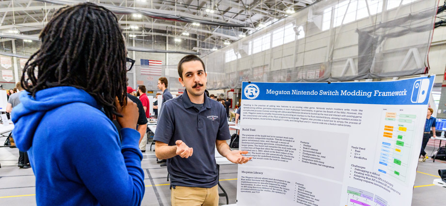 A student presents their trifold board at Rose Show.