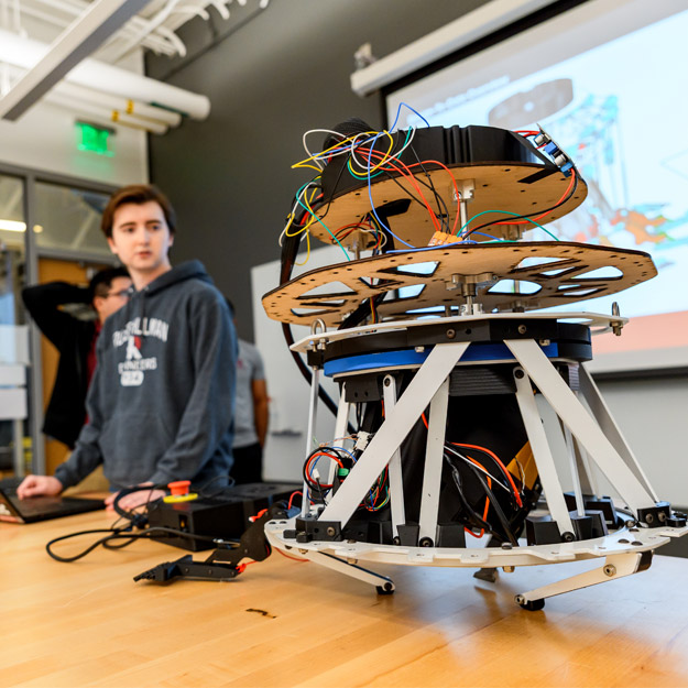 A student demonstrates a robot.