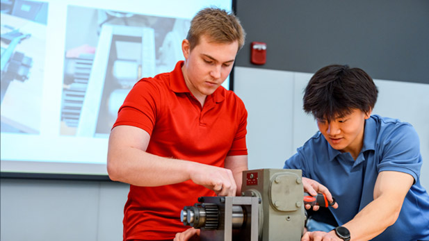 A student demonstrates a robot.