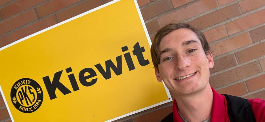 Palmer Schmidt takes a selfie by the Kiewit sign.